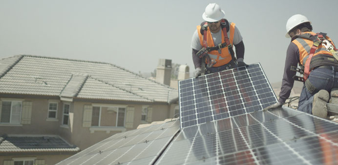 INSTALLATION: NRG Home Solar installers add rooftop solar panels to residences.