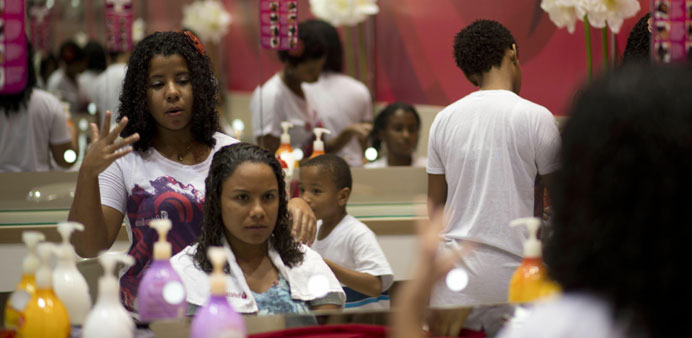 A woman gets ready to have her hair done at a hairdresseru2019s specialised in curling hair in Rio de Janeiro.