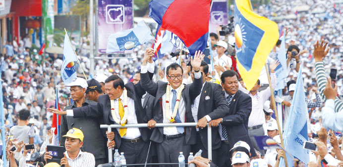    Sam Rainsy (centre), president of the National Rescue Party greets his supporters, in Phnom Penh, Cambodia yesterday.