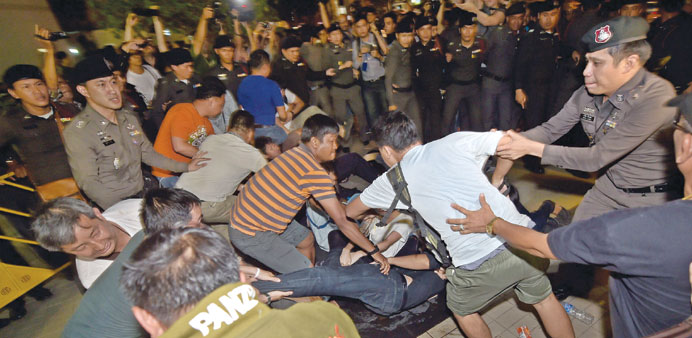 Thai police arrest students for demonstrating at a shopping mall in Bangkok on Friday.