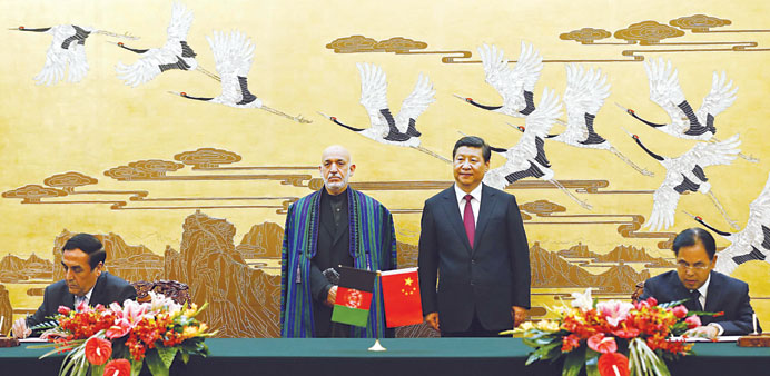   Chinese President Xi Jinping, centre right, and Afghan President Hamid Karzai, centre left, attending a signing ceremony at the Great Hall of the Pe