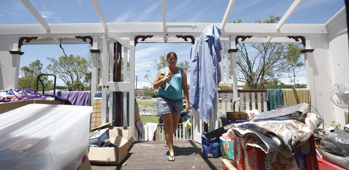 Yeppoon resident Demelza Bischoff walks onto the roofless veranda of her home, after it was damaged by Cyclone Marcia.