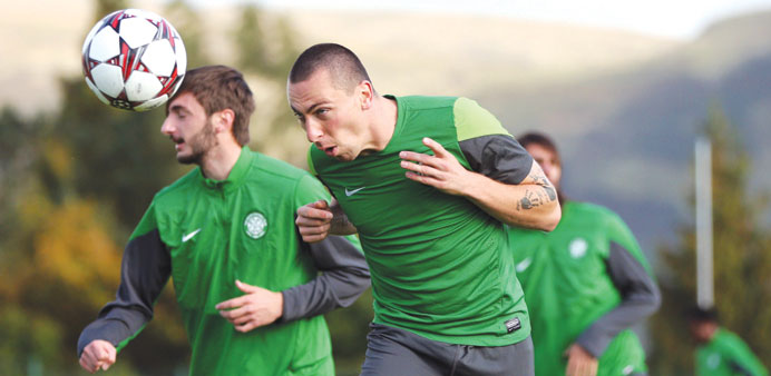 Celticu2019s Scottish midfielder Scott Brown (right) heads the ball during a training session in Glasgow, Scotland, yesterday, ahead of todayu2019s Champions 