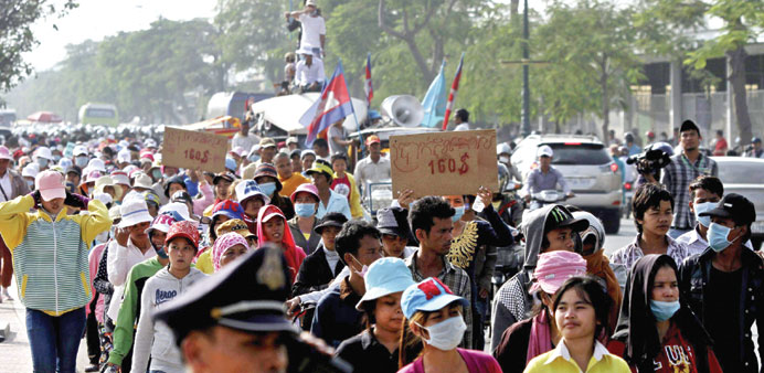 Garment workers march along a street near Prime Minister Hun Senu2019s office during a protest in central Phnom Penh yesterday.