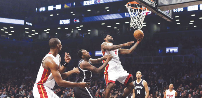 Miami Heat small forward LeBron James (third from left) looks to put up a basket past Brooklyn Nets center Andray Blatche (left) during the first half