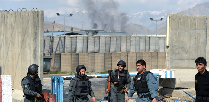 Smoke rises from the direction of the compound of the Afghan election commission during an attack by insurgents on the election centre in Kabul yester