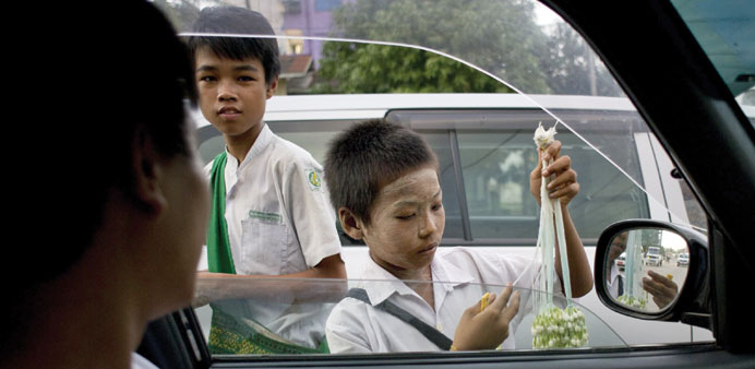 Children sell flowers on a road on the outskirts of Yangon. The impoverished country is the worldu2019s seventh worst for child labour, according to risk 