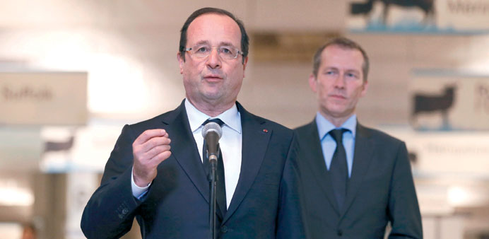 Hollande, flanked by Junior Minister for Food Industry Guillaume Garot, delivers a speech during his visit to the 50th International Agricultural Show