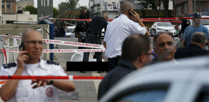 The body of a suspected stabber lays on the street after he was killed by an Israeli soldier in Tel Aviv