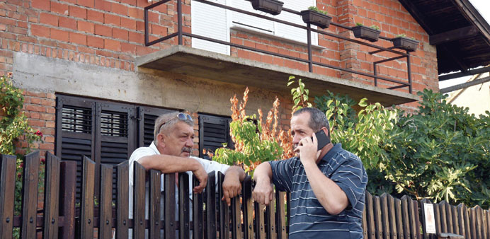 Friends of Salopek stand outside his home in Vrpolje, eastern Croatia, on Friday. 
