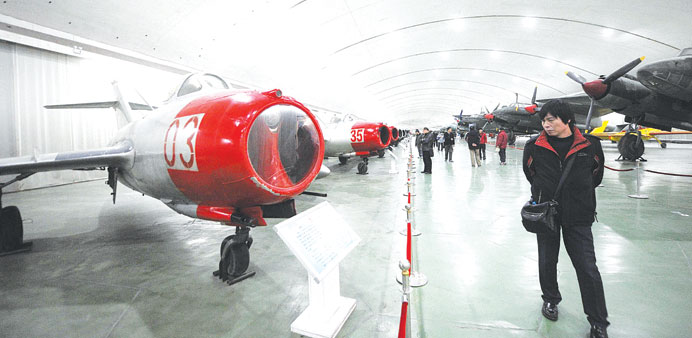 A man looks at Chinese aircraft from the Korean War on display during a visit to a museum in Beijing yesterday. China sent fighter jets and an early w