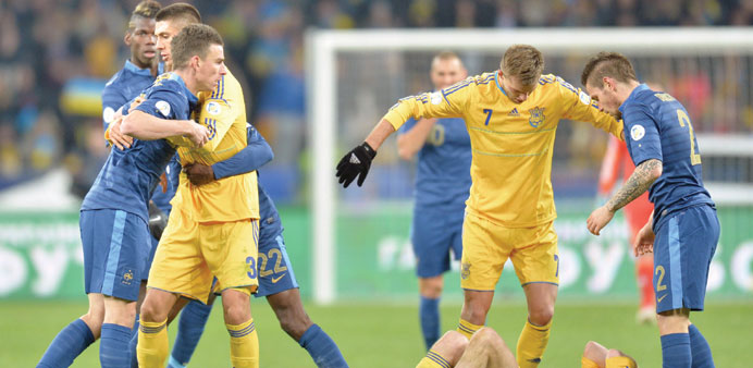 Players try to stop an argument between Franceu2019s Laurent Koscielny (left) and Ukraineu2019s Oleksandr Kucher (bottom) before they were both sent off durin