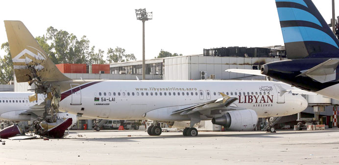 A damaged aircraft is seen on the tarmac at Tripoli International Airport yesterday after fighters from the Fajr Libya (Libyan Dawn) coalition reporte