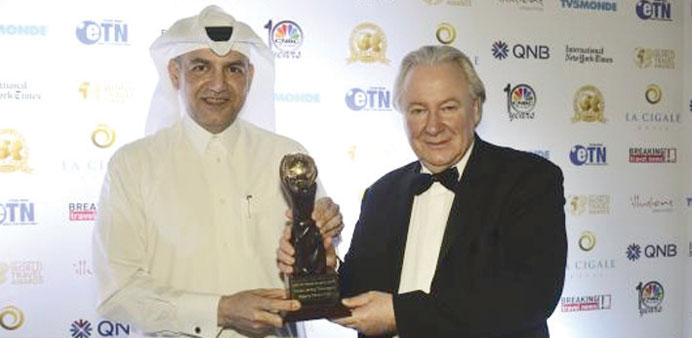 Tareq Abdullatif Taha receiving the award from Graham E Cooke, president of the World Travel Awards.
