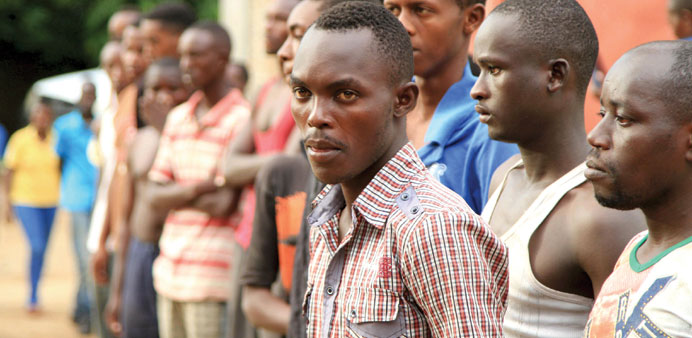 Suspected fighters are paraded before the media by Burundian police.