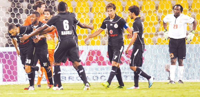 Al Sadd (in black) players celebrate a goal against Umm Salal during their 4-4 draw here yesterday. PICTURE: Noushad Thekkayil