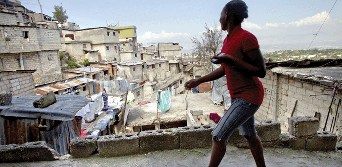Alexandra Simin, 25, walks through Jalousie, a mountaintop slum community overlooking Petionville. 