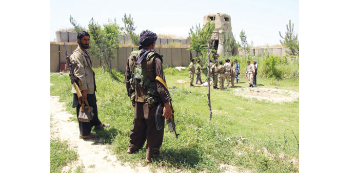  Afghan militias and policemen gather as they discuss during a battle at the Chardara district of Kunduz province earlier this month.