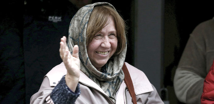 Belarussian author Svetlana Alexievich waves at a news conference in Minsk.