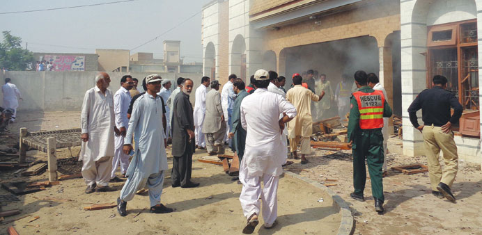 Tesidents gather at the site of a suspected suicide bomb attack in Taunsa town yesterday.
