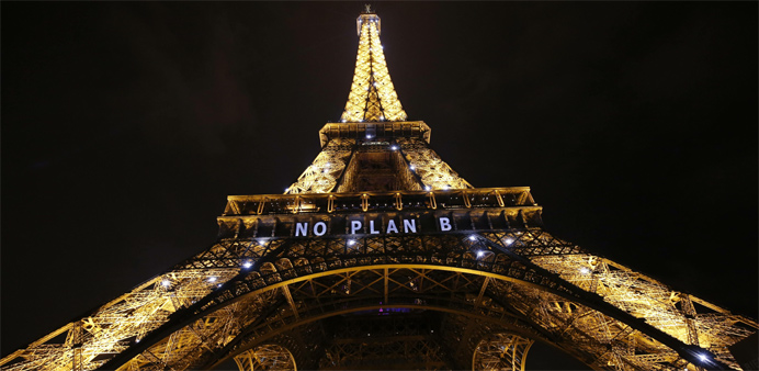 TOPSHOT - The Eiffel Tower displays the message ,No plan B, within the United Nations Climate Conference on Climate Change