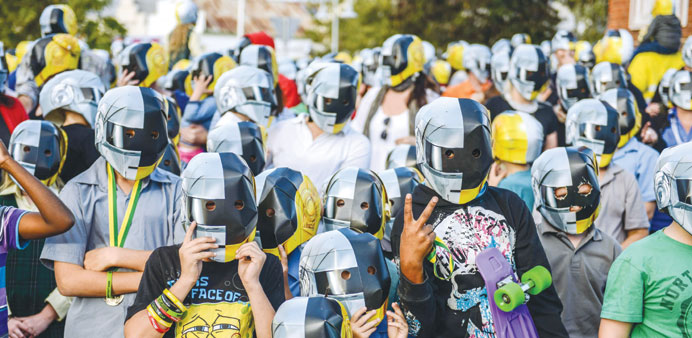 Fans with Daft Punk helmets pose for pictures on the eve of French group Daft Punku2019s album launch in Australiau2019s tiny town of Wee Waa yesterday.