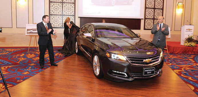 Jenkins and El-Houssami applaud after unveiling the new 2014 Chevrolet Impala.