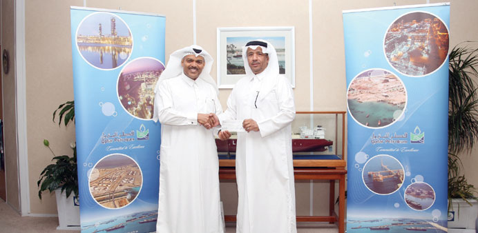 The cheque was presented by Abdulrahman Abdulla al-Obaidly to Brig Mohamed Saad al-Kharji