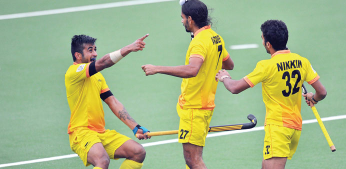 Indiau2019s Akashdeep Singh (left) celebrates after scoring a goal with teammates Manpreet Singh (centre) and Nikkin Thimmaiah during the semi-final again