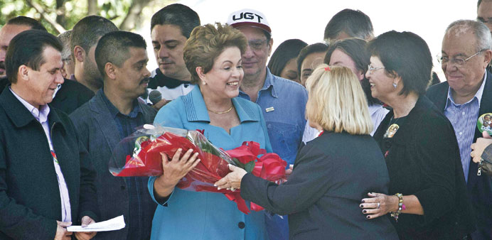 Brazilian President Dilma Rousseff receives flowers during a rally in Sao Paulo.