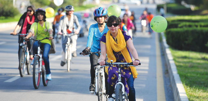 Pakistani women ride their bikes towards the cityu2019s landmark Faisal Mosque to mark International Womenu2019s day in Islamabad yesterday.