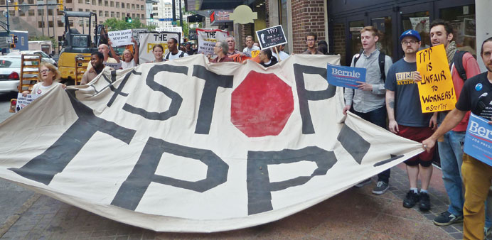 Protesters call for the rejection of the Trans-Pacific Partnership trade deal under negotiation in Atlanta.