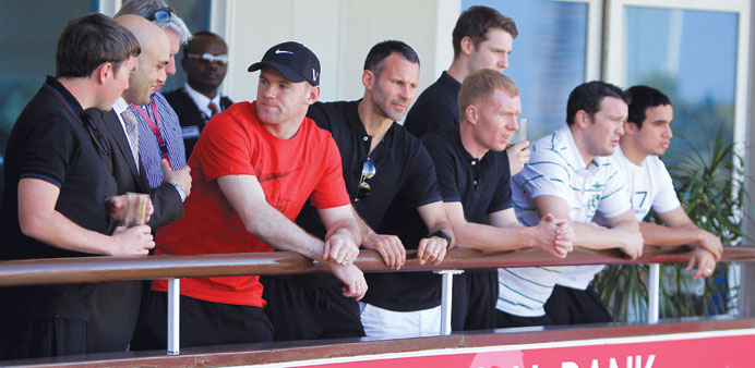 Manchester United stars Wayne Rooney (red shirt), Ryan Giggs and Paul Scholes on the balcony of the Commercial Bank Hospitality Tent at the Commercial