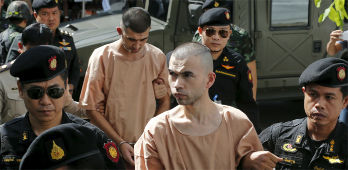 Suspects of the August 17 Bangkok blast, Bilal Mohammed (also known as Adem Karadag) and Yusufu Mieraili are escorted by soldiers