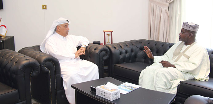 Saleh bin Ali al-Mohannadi, and Haqqar Mohamed Ahmed during a meeting.