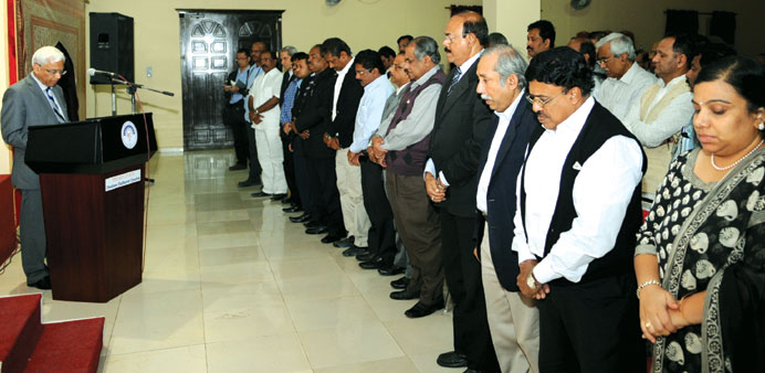 Sanjiv Arora and members of the community observing a moment of silence yesterday for the victims of the recent LPG tank explosion. PICTURE: Shemeer R