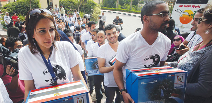 Supporters of Hamdeen Sabbahi submit documents required for his candidacy to the presidential elections commission in Cairo yesterday.