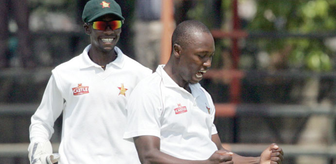 HIGH FIVE: Zimbabwe bowler Tendai Chatara (right) celebrates a Pakistan wicket with teammate Richmond Mutumbami. The pacer took 5 for 61. (AFP) 