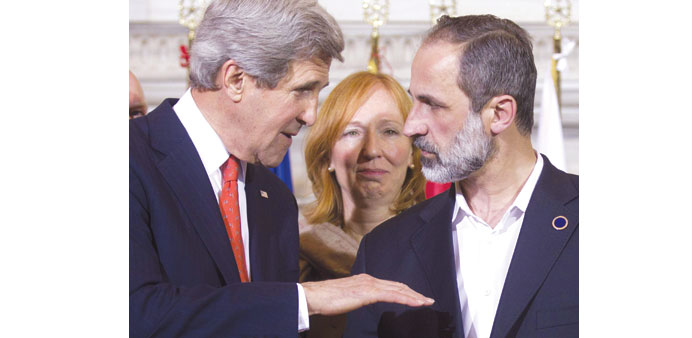 US Secretary of State John Kerry and National Coalition chief Moaz al-Khatib chat during a meeting of the Friends of the Syrian Peopleu2019s (FOSP) minist