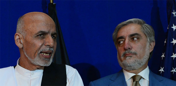 Afghan presidential candidate Ashraf Ghani (L) speaks as opponent Abdullah Abdullah looks on. -AFP