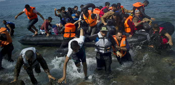 Refugees and migrants arrive on a dinghy on the Greek island of Lesbos