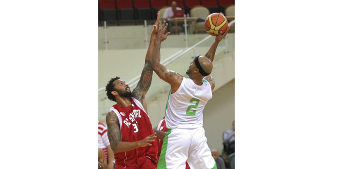 Al Ahliu2019s Holland Delonte (right) rises above an Al Shamal player during their Basketball League match yesterday. PICTURE: Othman Iraqi