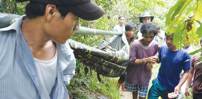Ho Van Lang who is about 41 years old and his 81-year-old father Ho Van Thanh (in the hammock).