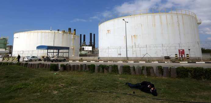 A Palestinian worker takes rest next to the Gazy City power plant yesterday after it shut down due to a lack of fuel.