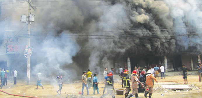 Firefighters try to control a fire after garment workers set fire in a spinning mill in Gazipur, near Dhaka, yesterday.