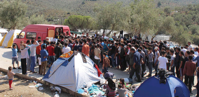 Non-Syrian refugees jostle for food at a volunteer distribution in Moria camp, Lesvos. Many have spent all their money getting to Greece and have no c