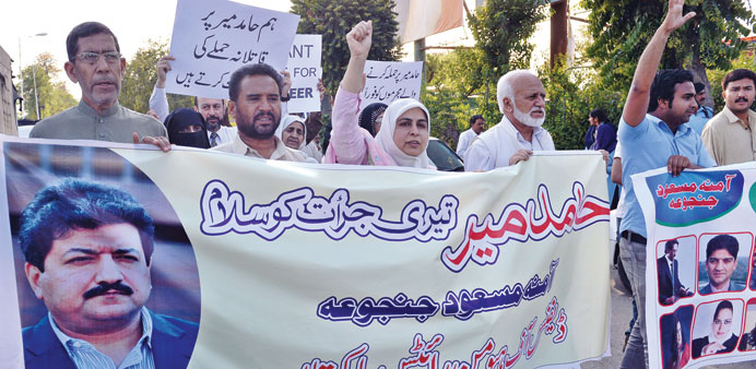 Pakistani activists from the Defence of Human Rights Pakistan organisation shout slogans during a protest in Islamabad against the attack on televisio