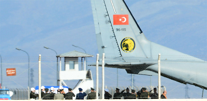 The coffin of the pilot killed when Turkey shot down a Russian jet is carried to a Turkish Air Force Cargo Aircraft, before being handed over to Russi
