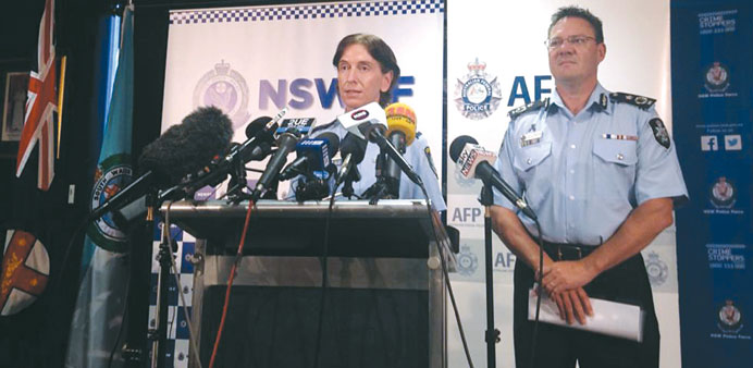 Australian Federal Police Deputy Commissioner Michael Phelan listens as New South Wales Deputy Police Commissioner Catherine Burn speaks during a medi