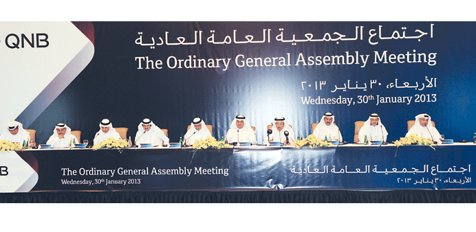 HE Kamal addresses the shareholders at the AGM yesterday in the presence other QNB board members